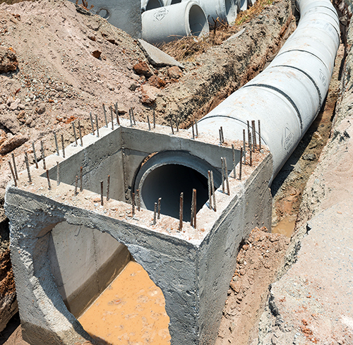 Row of Concrete Drainage Pipe on a Construction Site .Concrete p