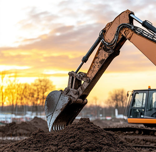 An excavator is diligently digging into the earth at a construct